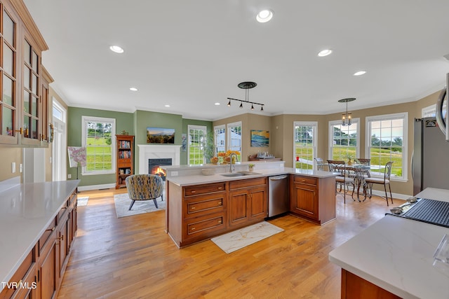 1905 Martin Rd, Limestone, TN 37681 - kitchen with stainless steel appliances, ornamental molding, a sink, brown cabinets, and a lit fireplace