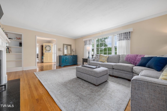 134 Parkland Dr, Bristol, VA 24201 - living area with crown molding, a fireplace with flush hearth, wood finished floors, built in shelves, and baseboards