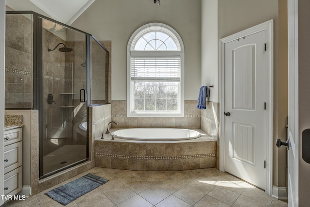 2909 Greenline Rd, Johnson City, TN 37604 - bathroom featuring a bath, plenty of natural light, a stall shower, tile patterned flooring, and vaulted ceiling