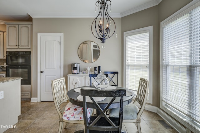 2909 Greenline Rd, Johnson City, TN 37604 - dining area featuring crown molding, a chandelier, light tile patterned floors, and baseboards