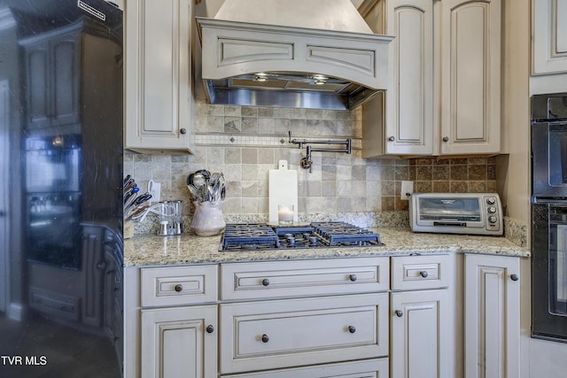2909 Greenline Rd, Johnson City, TN 37604 - kitchen with premium range hood, black appliances, tasteful backsplash, and light stone countertops