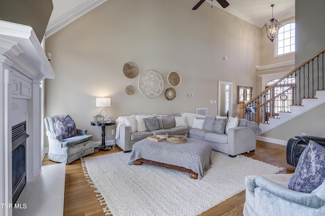 2909 Greenline Rd, Johnson City, TN 37604 - living room with a fireplace, crown molding, stairway, ceiling fan, and a high ceiling
