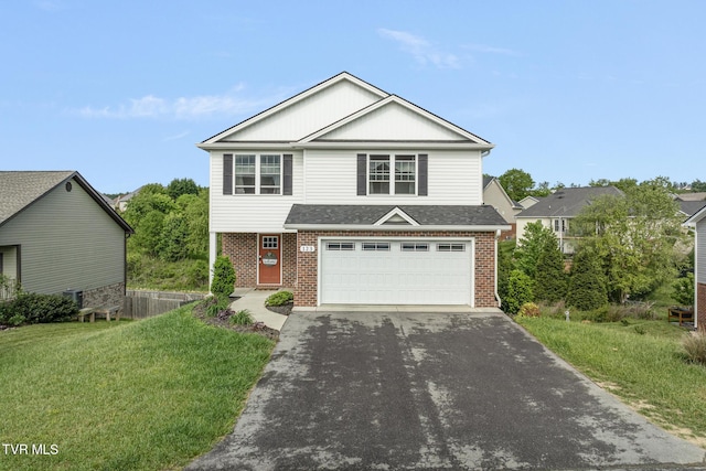 view of front of home with brick siding, asphalt driveway, a garage, and a front yard