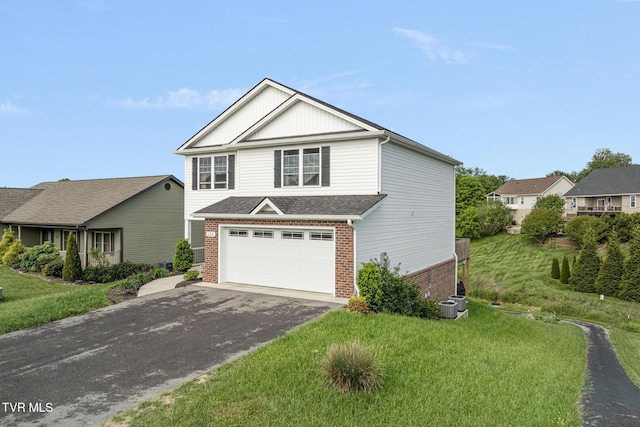 view of front of home featuring brick siding, asphalt driveway, an attached garage, and a front lawn