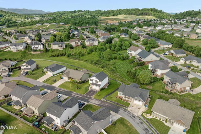 aerial view of property and surrounding area featuring nearby suburban area