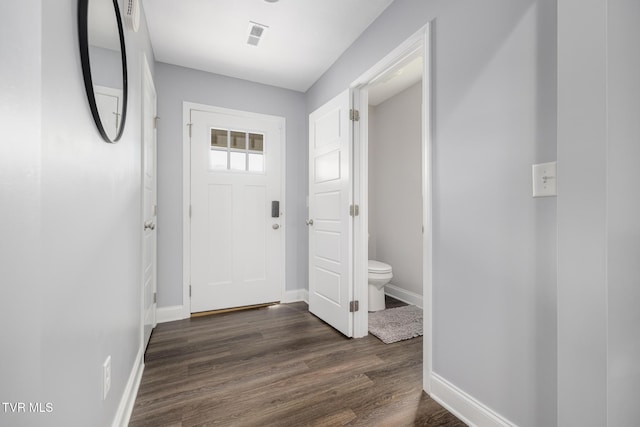 doorway with baseboards and dark wood-style flooring