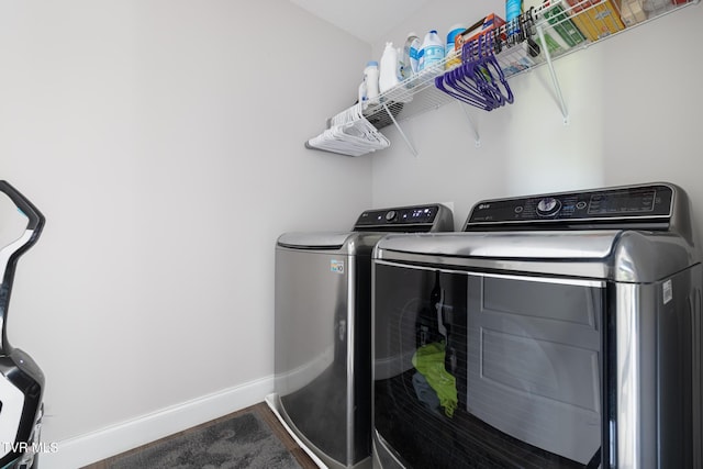 laundry area featuring washing machine and dryer and baseboards