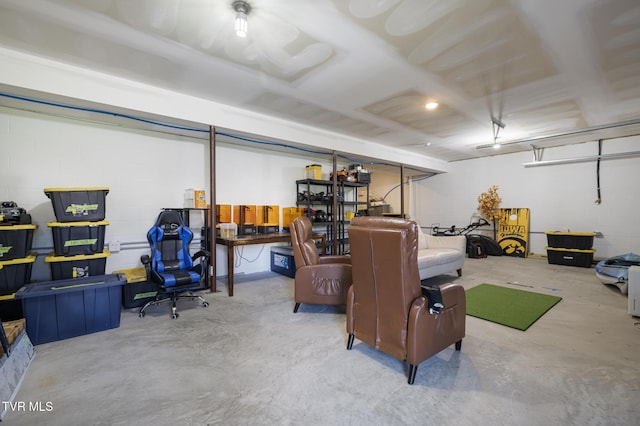 basement with concrete block wall and a garage