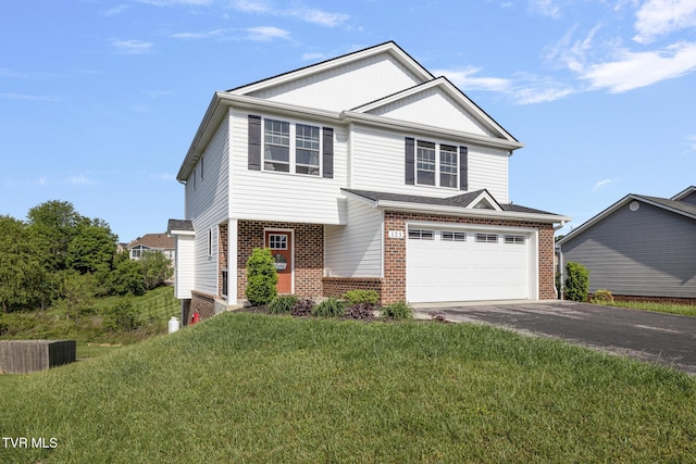 view of front facade with brick siding, driveway, a garage, and a front yard