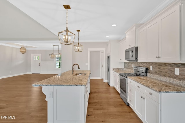 kitchen featuring appliances with stainless steel finishes, a sink, ornamental molding, backsplash, and white cabinets