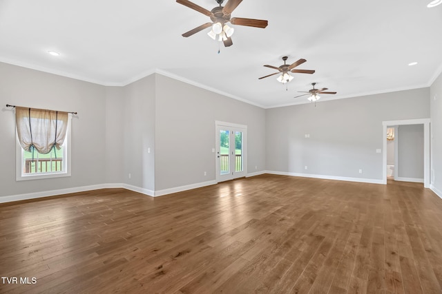 unfurnished room featuring ceiling fan, wood finished floors, crown molding, and baseboards