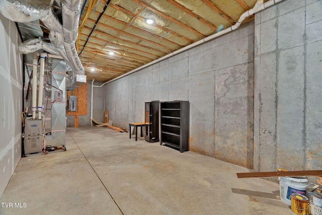 unfinished basement featuring heating unit