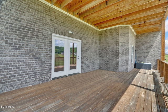 wooden terrace with central air condition unit and french doors