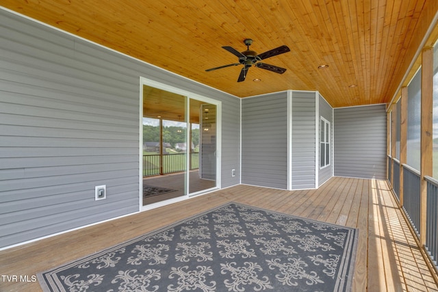 unfurnished sunroom featuring ceiling fan