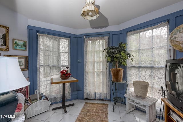 sitting room featuring plenty of natural light and light tile patterned floors