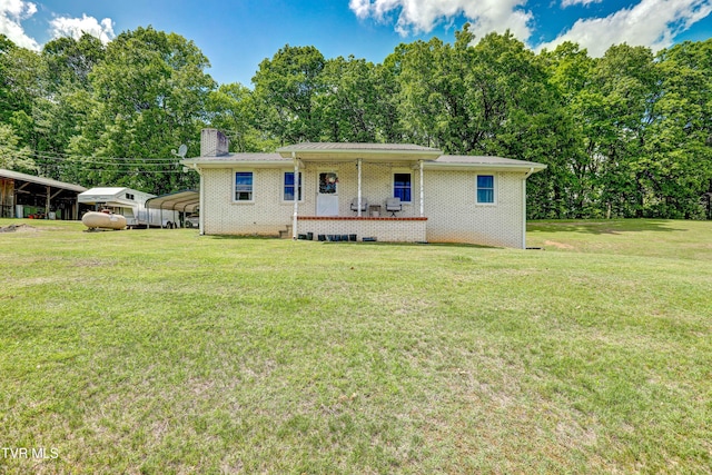 135 Abc Rd, Limestone, TN 37681 - view of front of house featuring a front yard, a detached carport, a chimney, and view of wooded area