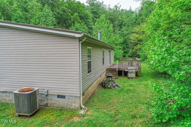 596 Devils Nose Rd, Rogersville, TN 37857 - view of side of property featuring crawl space, central AC, a wooden deck, a lawn, and a wooded view