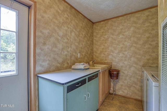 596 Devils Nose Rd, Rogersville, TN 37857 - kitchen with independent washer and dryer, a textured ceiling, ornamental molding, a sink, and light countertops
