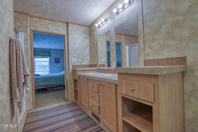 596 Devils Nose Rd, Rogersville, TN 37857 - full bath featuring a textured ceiling, ornamental molding, wallpapered walls, vanity, and connected bathroom