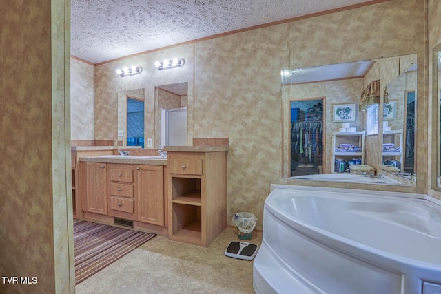 596 Devils Nose Rd, Rogersville, TN 37857 - bathroom featuring crown molding, a textured ceiling, tile patterned flooring, a garden tub, and vanity
