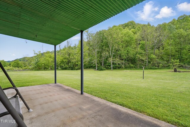 view of patio / terrace with a wooded view