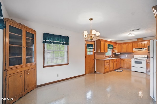 kitchen with white appliances, a chandelier, under cabinet range hood, a sink, and glass insert cabinets