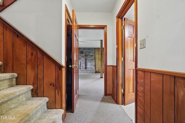 stairs featuring carpet flooring and a wainscoted wall
