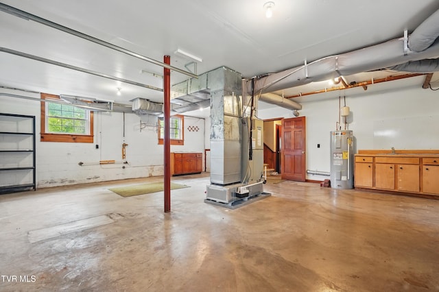 garage with water heater, heating unit, and a sink