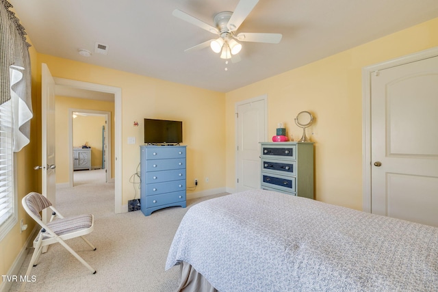 carpeted bedroom with baseboards and a ceiling fan
