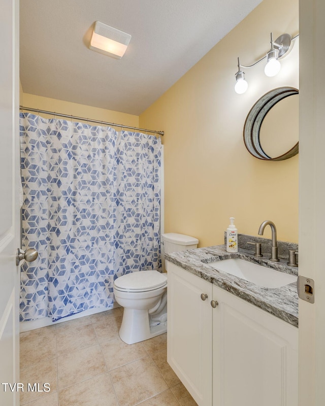 full bathroom featuring toilet, vanity, tile patterned floors, and a shower with shower curtain