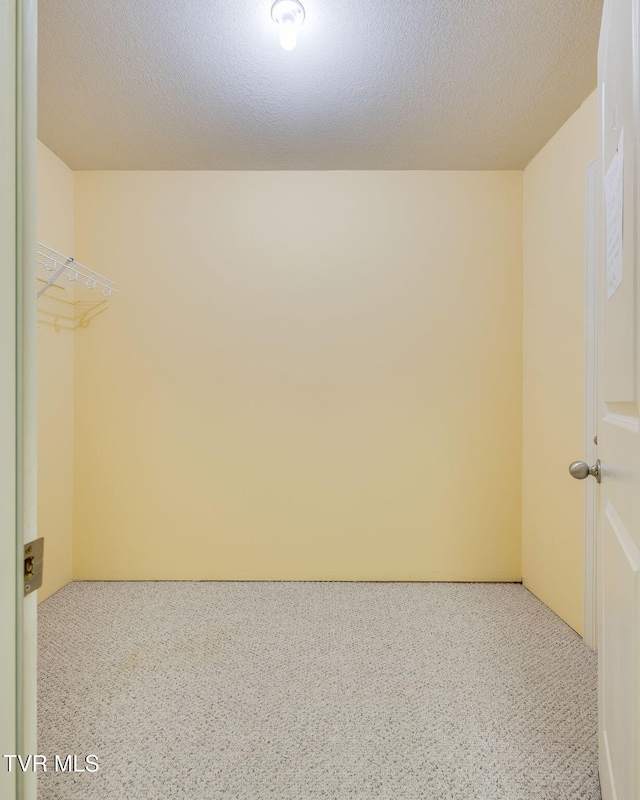 unfurnished room featuring a textured ceiling