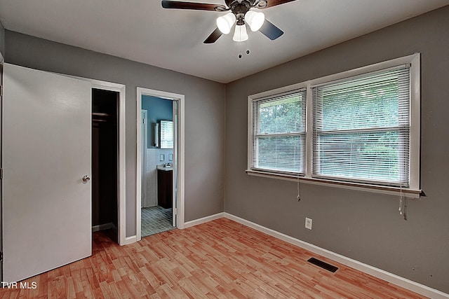 416 Ridgefields Rd, Kingsport, TN 37660 - unfurnished bedroom featuring light wood-style floors, baseboards, ensuite bathroom, and a ceiling fan