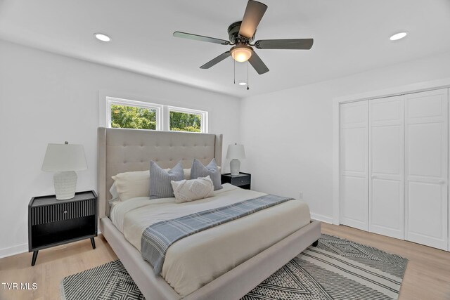 bedroom featuring light wood-style flooring, heating unit, a closet, recessed lighting, and a ceiling fan