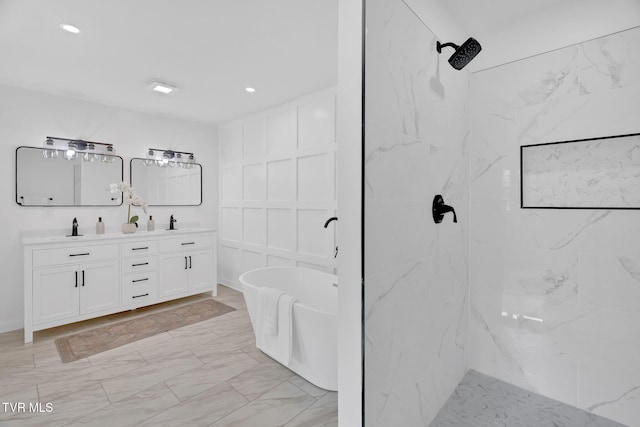 bathroom featuring double vanity, a shower, a freestanding tub, and recessed lighting