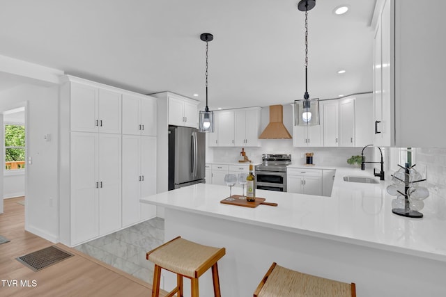 kitchen with a sink, appliances with stainless steel finishes, custom exhaust hood, recessed lighting, and decorative backsplash