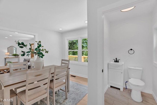 dining space featuring baseboards and recessed lighting
