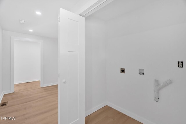 clothes washing area featuring electric dryer hookup, light wood-type flooring, recessed lighting, and baseboards