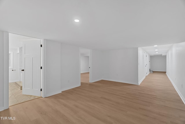basement with light wood-style floors, baseboards, and recessed lighting