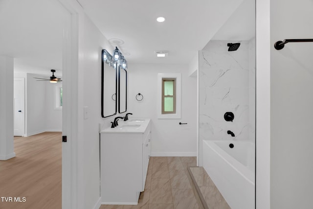 bathroom with vanity, baseboards, shower / tub combination, ceiling fan, and marble look tiles