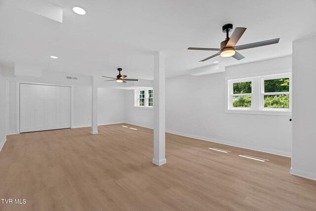 basement with a ceiling fan, light wood-style flooring, baseboards, and recessed lighting