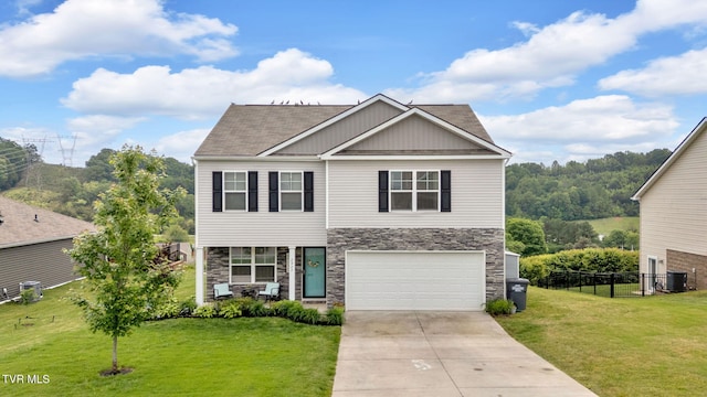 view of front of property featuring stone siding, concrete driveway, central air condition unit, an attached garage, and a shingled roof