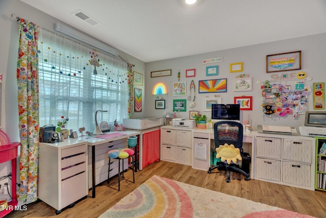 kitchen with light wood-style floors, light countertops, and an office area