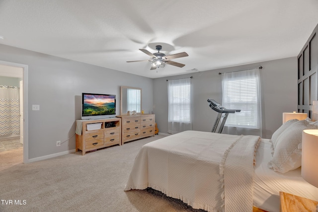 bedroom with light colored carpet, baseboards, and ceiling fan