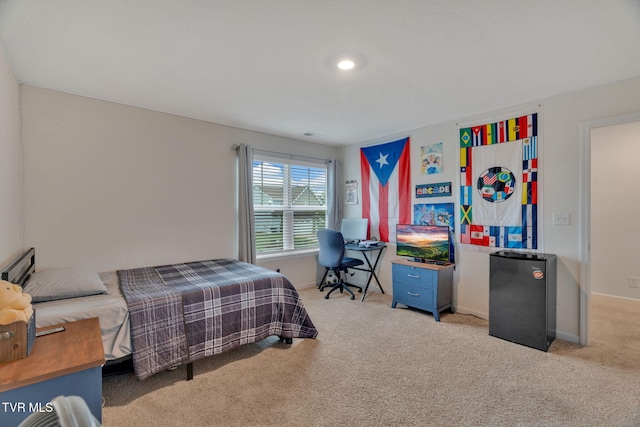 bedroom with light carpet, baseboards, and fridge