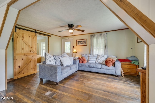 894 Mountain View Rd, Rogersville, TN 37857 - living area featuring crown molding, a barn door, ceiling fan, dark wood-style floors, and a textured ceiling