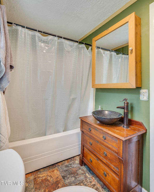 894 Mountain View Rd, Rogersville, TN 37857 - bathroom featuring vanity, shower / bath combo, stone finish floors, toilet, and a textured ceiling