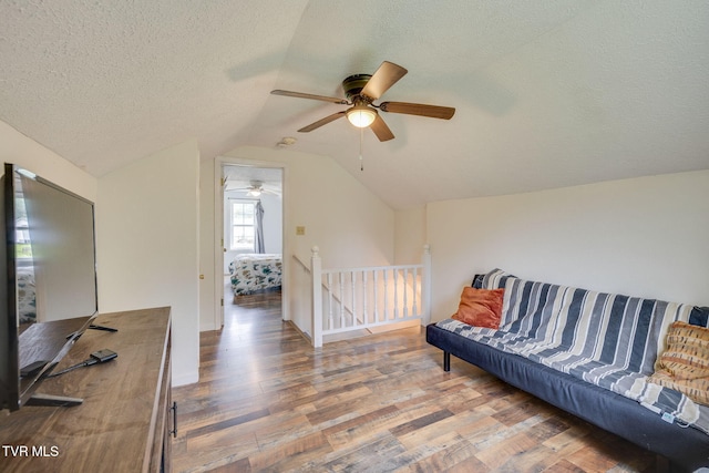 894 Mountain View Rd, Rogersville, TN 37857 - sitting room with a ceiling fan, wood finished floors, vaulted ceiling, an upstairs landing, and a textured ceiling