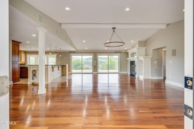 20484 Lake Rd, Abingdon, VA 24211 - unfurnished living room featuring light wood-style floors, recessed lighting, decorative columns, baseboards, and a glass covered fireplace