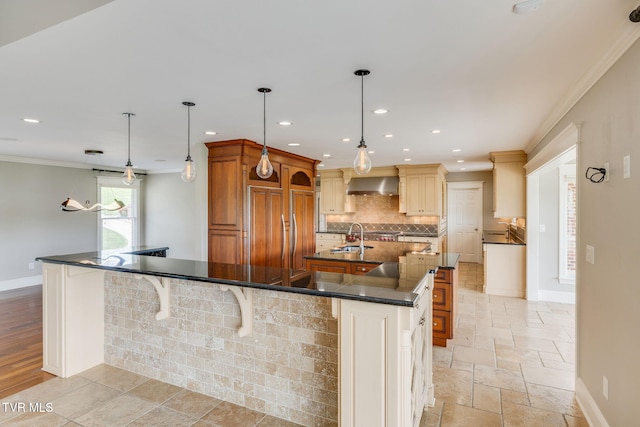 20484 Lake Rd, Abingdon, VA 24211 - kitchen with wall chimney range hood, crown molding, a large island, decorative backsplash, and a sink