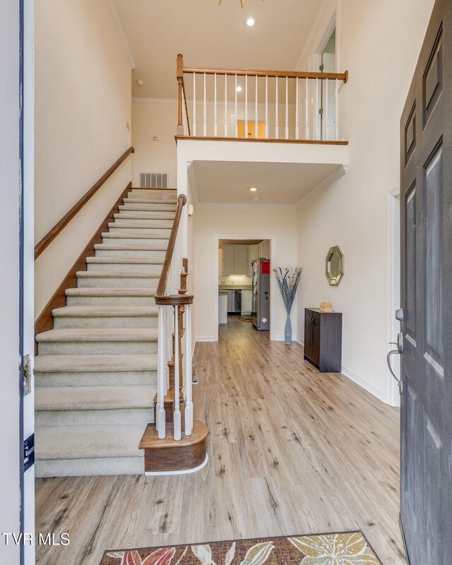 3502 Bondwood Cir, Johnson City, TN 37604 - foyer entrance featuring ornamental molding, stairway, wood finished floors, baseboards, and a high ceiling